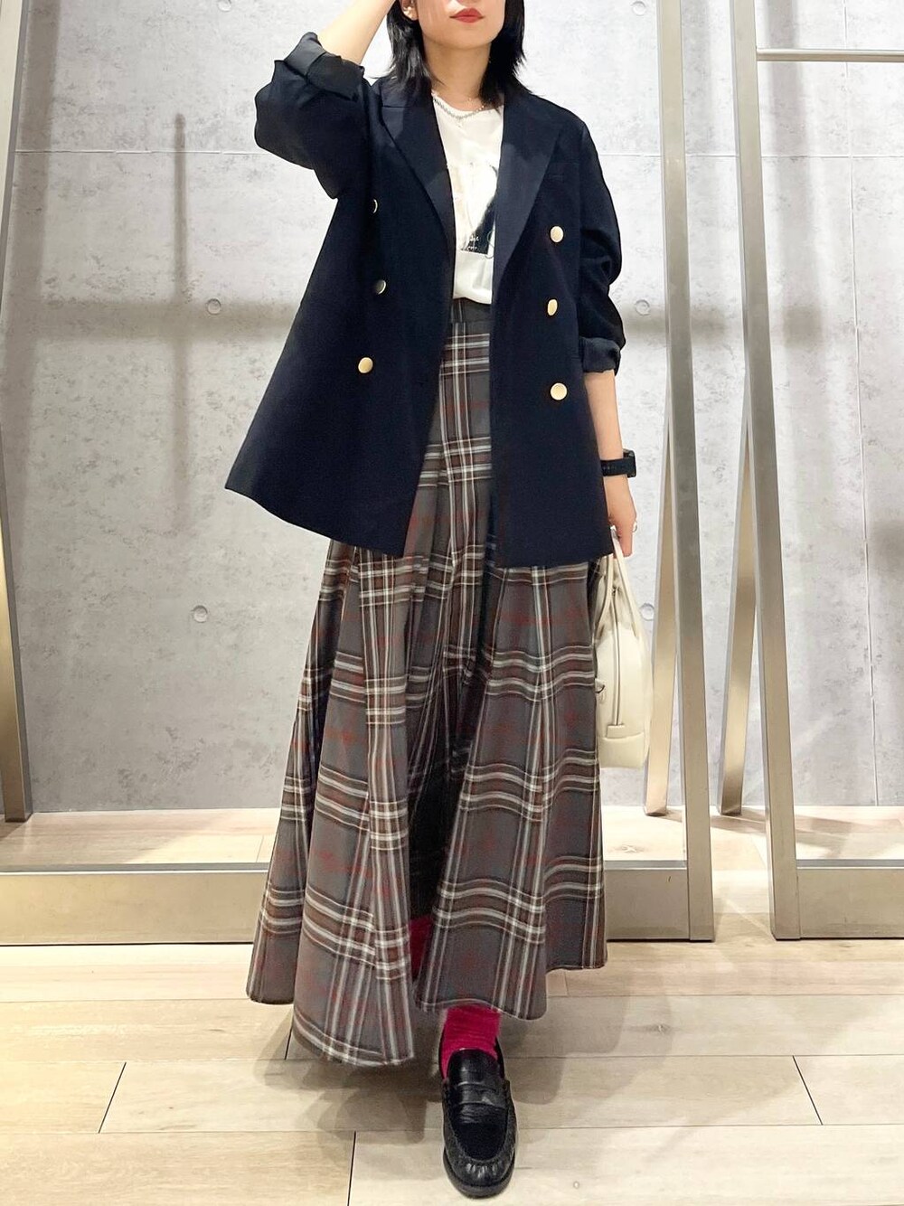 ブルー系のテーラードジャケット、ホワイト系のボストンバッグ、ブラック系のローファーを着用したレディースの秋コーディネートの1枚目の写真