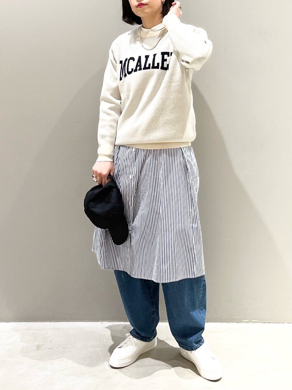 ホワイト系のニット/セーター、ブルー系のデニムパンツ、ホワイト系のスニーカーを着用したレディースの冬コーディネートの1枚目の写真
