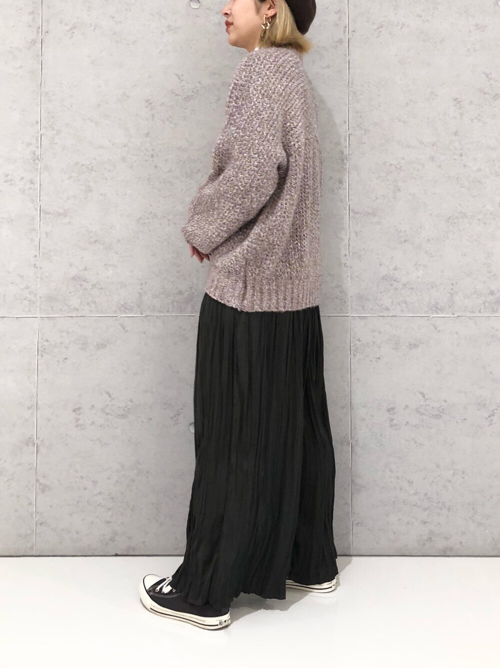 パープル系のニット/セーター、グレー系のその他パンツ、グレー系のスニーカーを着用したレディースの冬コーディネートの4枚目の写真