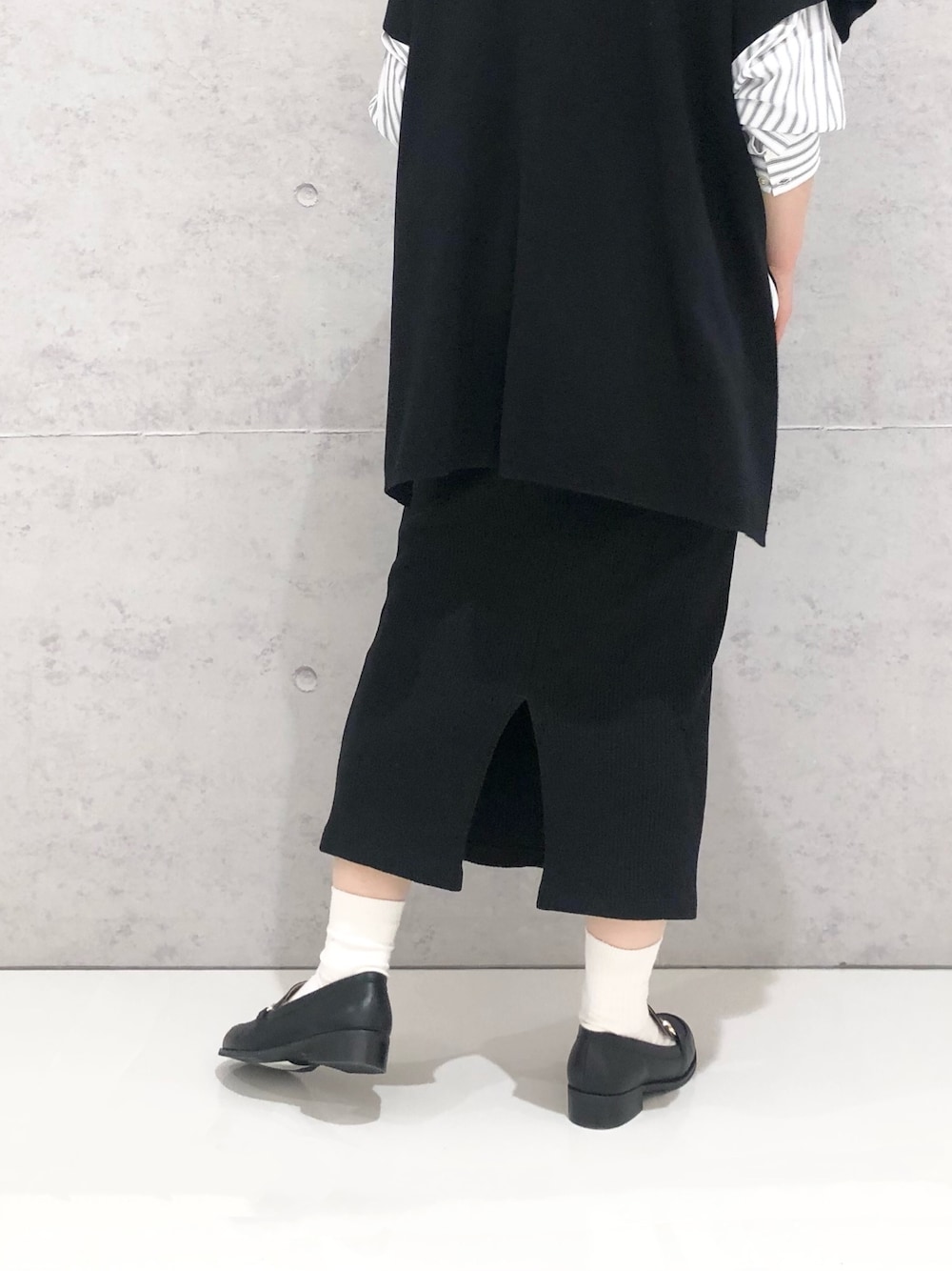 グレー系のシャツ/ブラウス、ブラック系のベスト、グリーン系のショルダーバッグを着用したレディースの春コーディネートの2枚目の写真