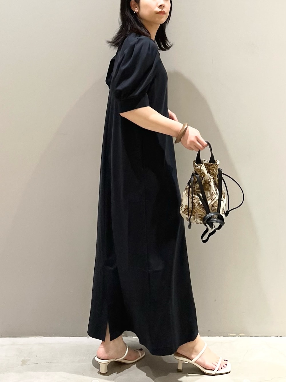 ブラック系のワンピース/ドレス、ホワイト系のサンダル、ブラウン系のショルダーバッグを着用したレディースの夏コーディネートの3枚目の写真