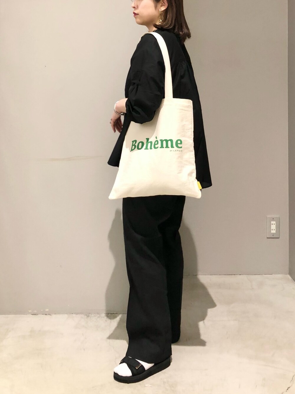 ブラック系のサンダル、ブラック系のその他パンツ、ホワイト系のトートバッグを着用したレディースの春コーディネートの3枚目の写真