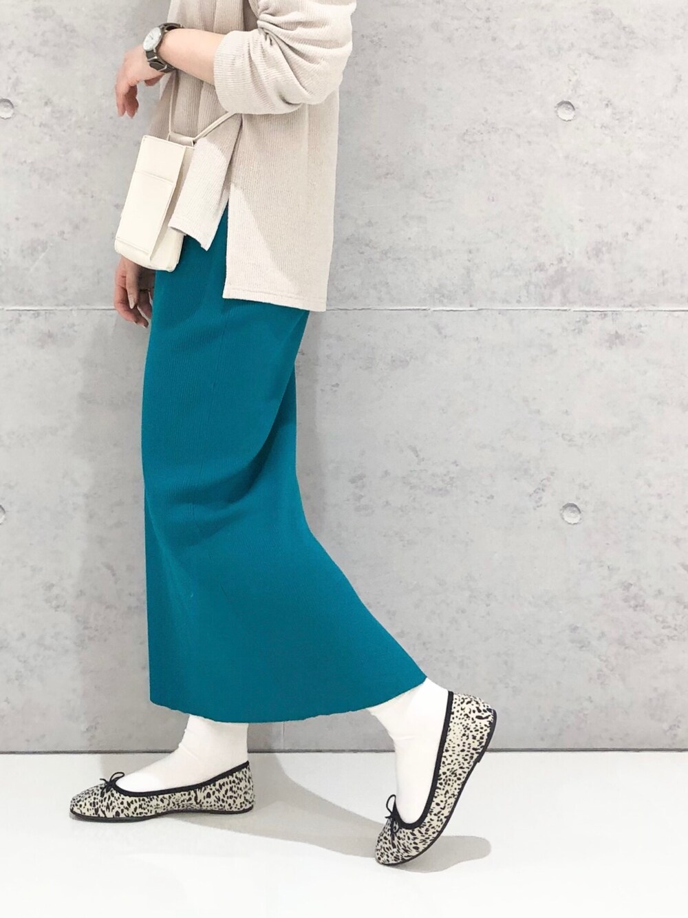 グリーン系のスカート、その他のバレエシューズ、ホワイト系のショルダーバッグを着用したレディースの冬コーディネートの4枚目の写真