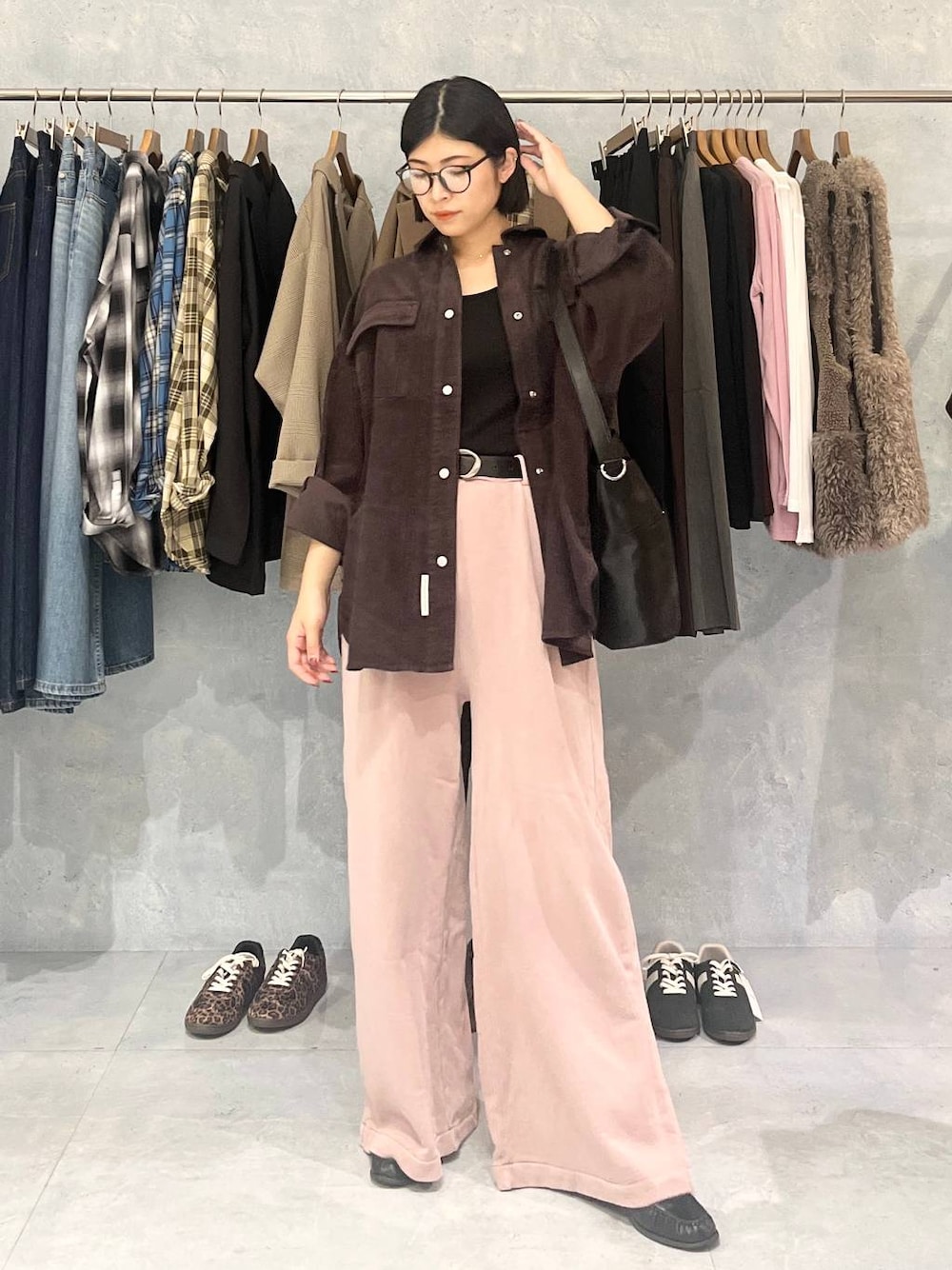 ピンク系のスウェットパンツ、ブラック系のショルダーバッグ、ブラウン系のシャツ/ブラウスを着用したレディースの秋コーディネートの1枚目の写真