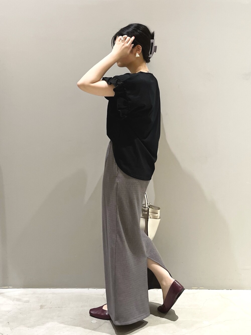 ブラック系のTシャツ/カットソー、ブラウン系のスカート、パープル系のパンプスを着用したレディースの夏コーディネートの3枚目の写真