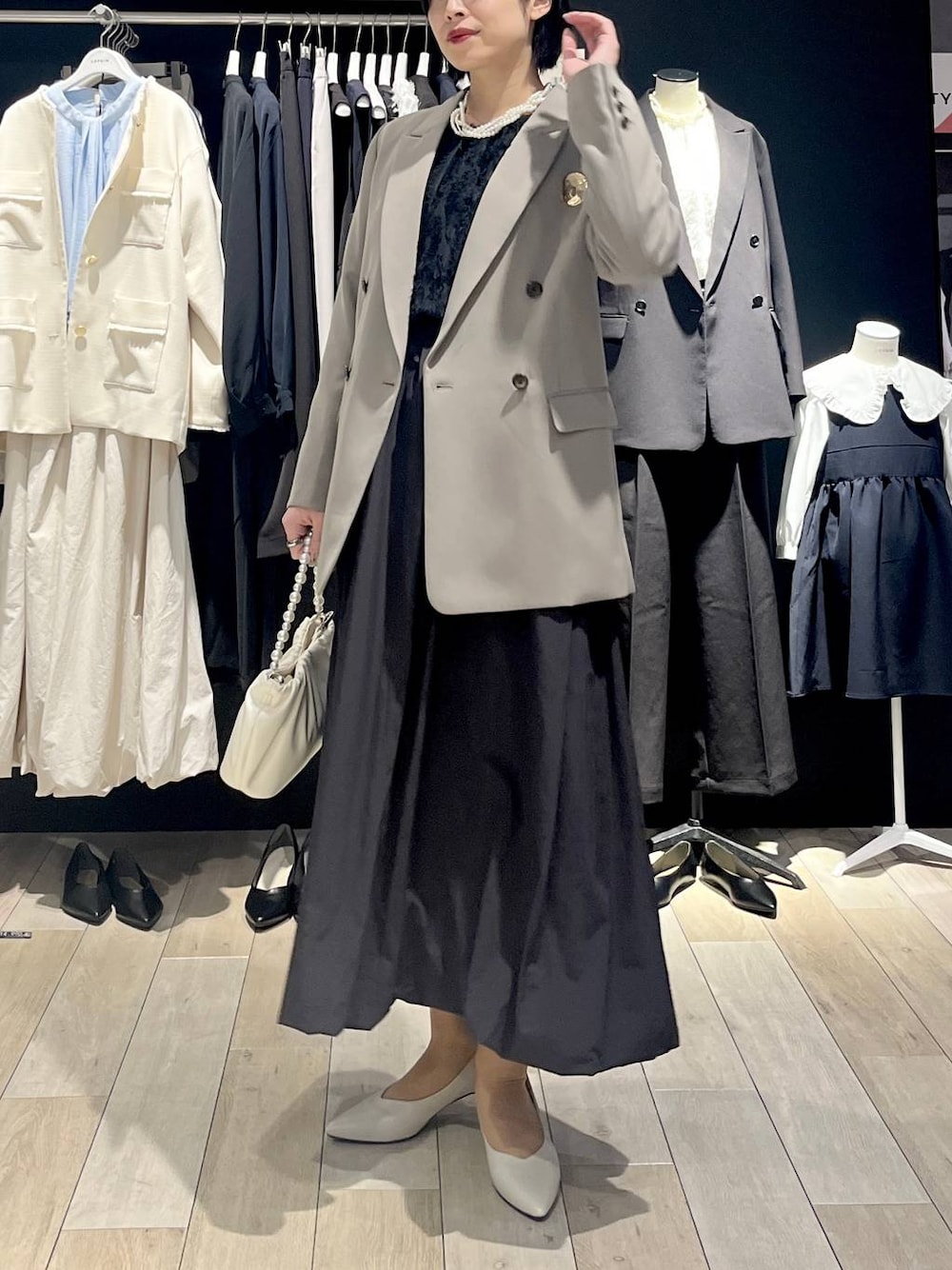 ブラウン系のテーラードジャケット、ブラック系のスカート、ブラック系のシャツ/ブラウスを着用したレディースの冬コーディネートの1枚目の写真