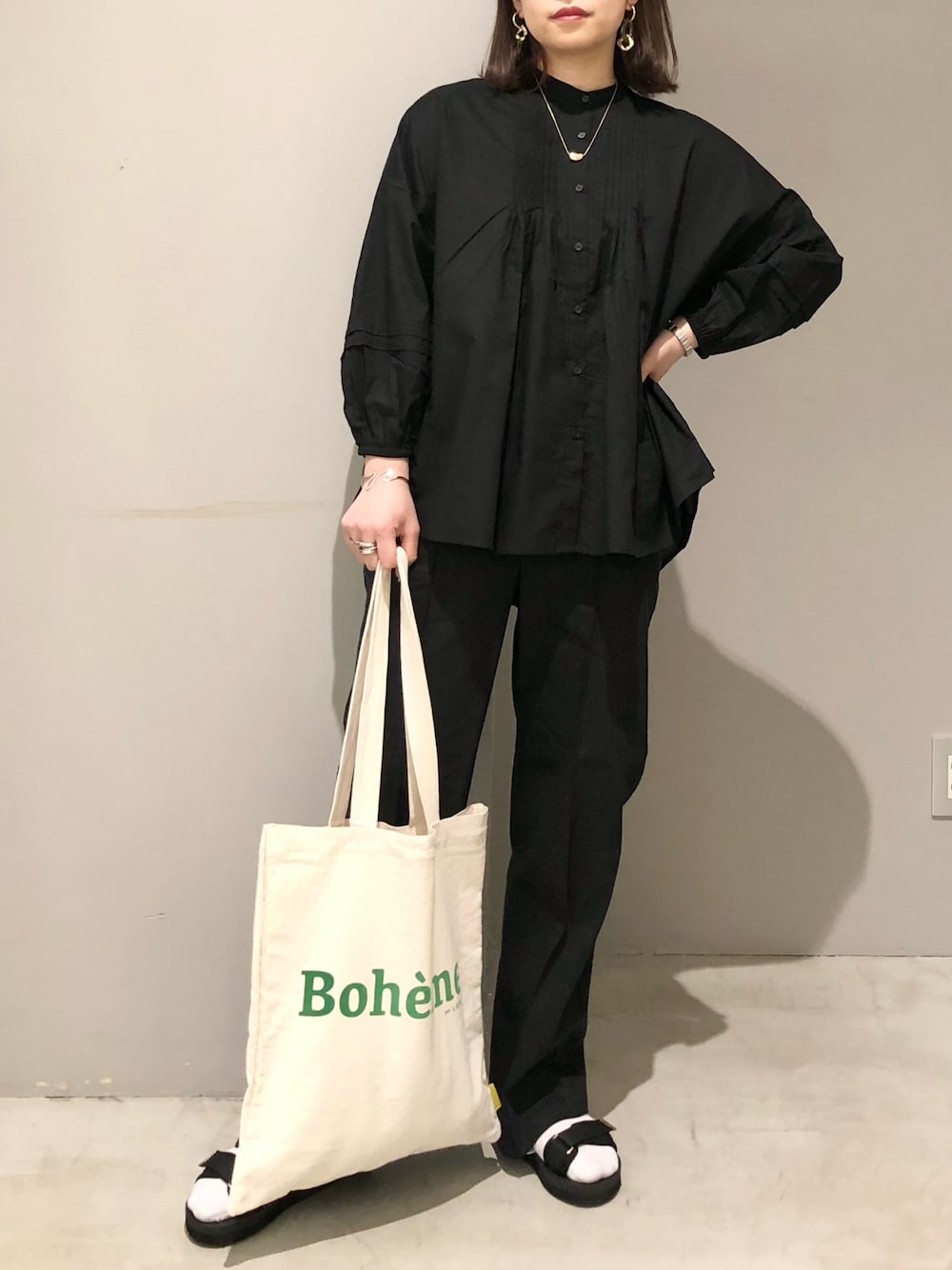 ブラック系のサンダル、ブラック系のその他パンツ、ホワイト系のトートバッグを着用したレディースの春コーディネートの4枚目の写真