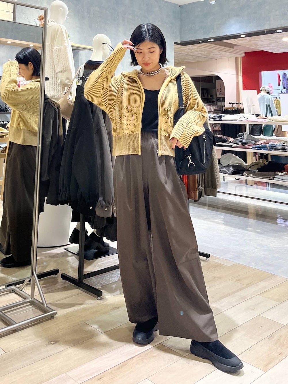 ブラウン系のその他パンツ、ブラック系のその他シューズ、ブラック系のショルダーバッグを着用したレディースの冬コーディネートの1枚目の写真