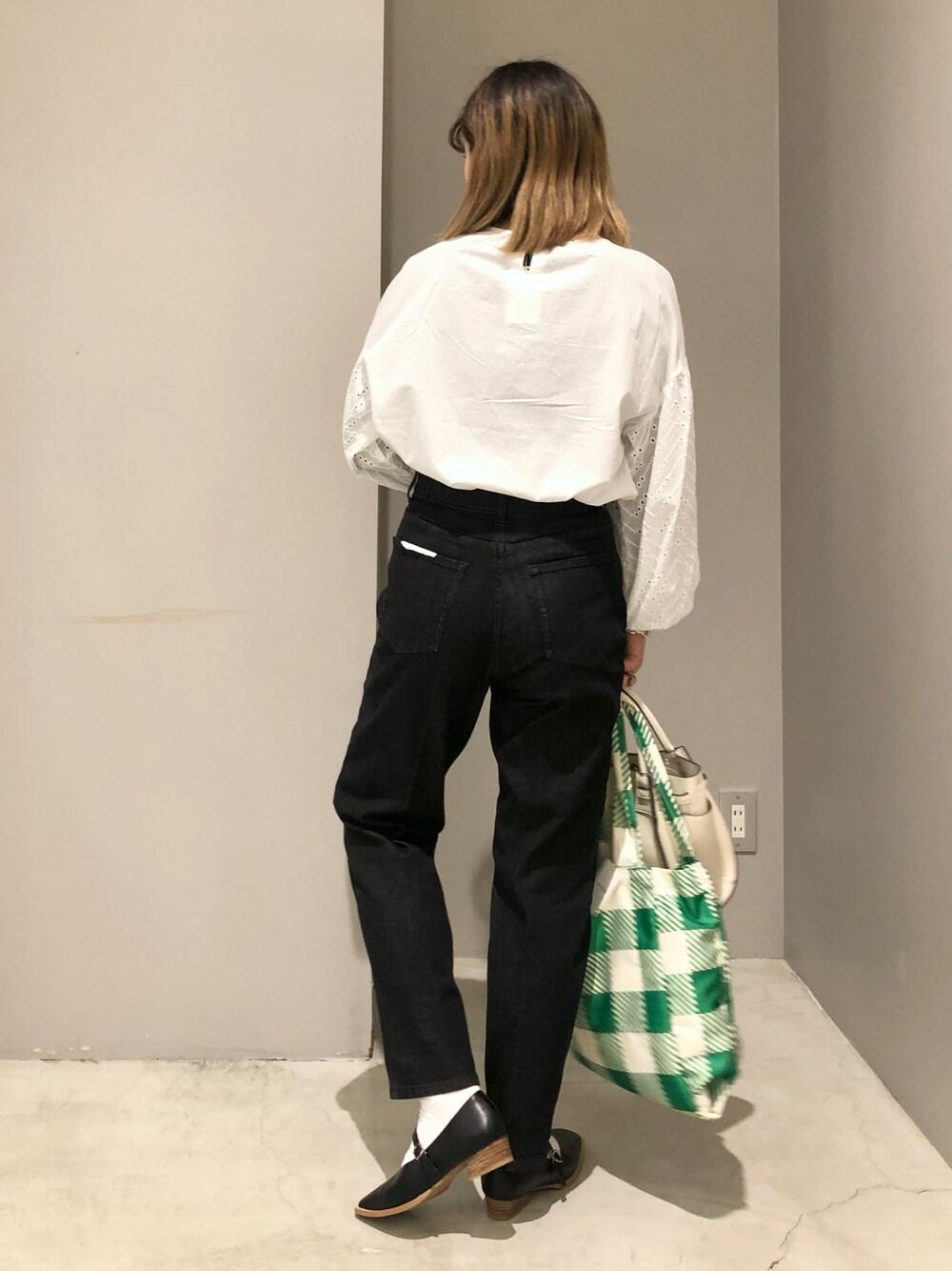 ホワイト系のショルダーバッグ、グリーン系のショルダーバッグ、ブラック系のパンプスを着用したレディースの春コーディネートの3枚目の写真