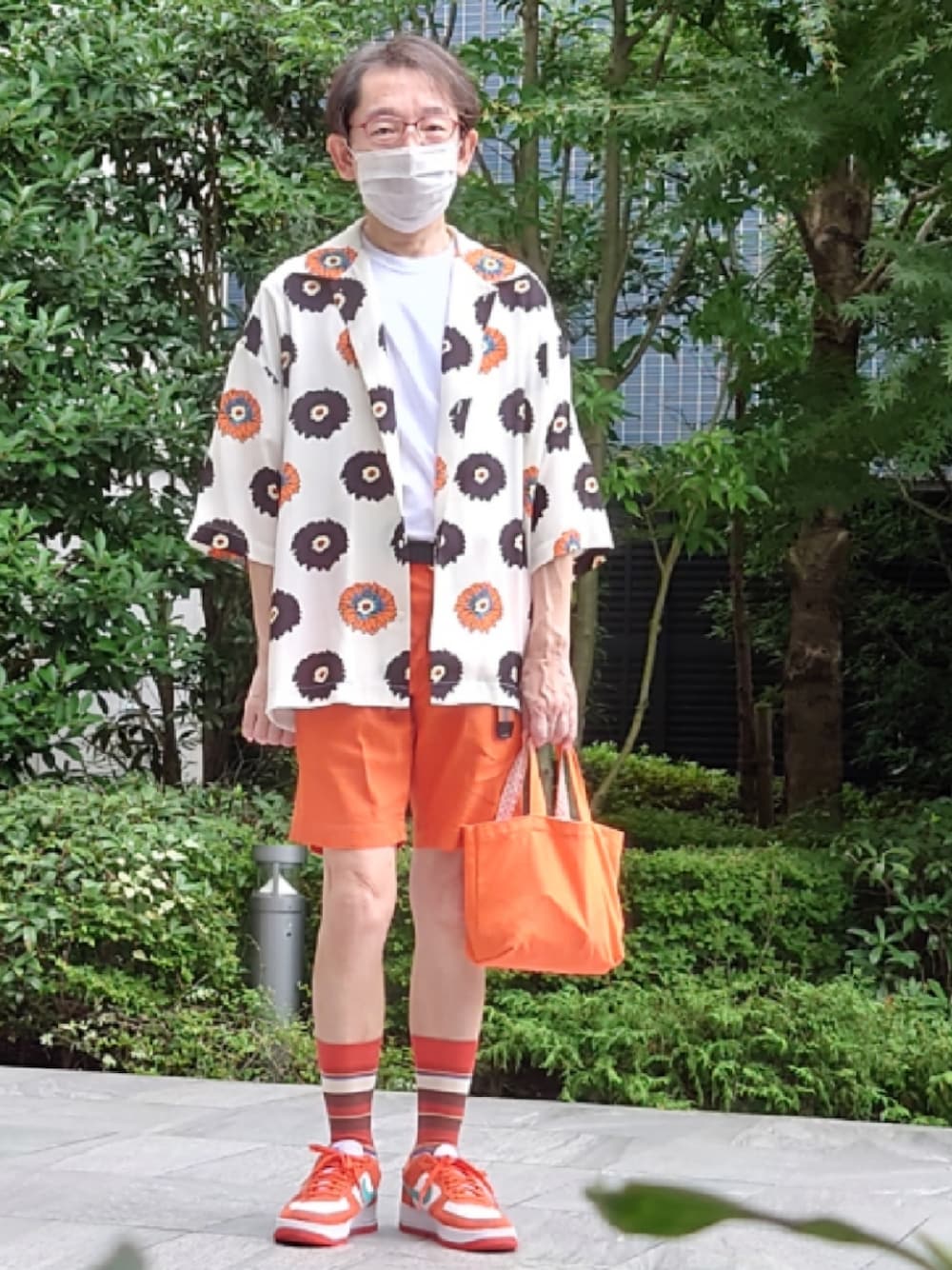 オレンジ系のトートバッグ、オレンジ系のその他パンツ、オレンジ系のスニーカーを着用したメンズの夏コーディネートの1枚目の写真