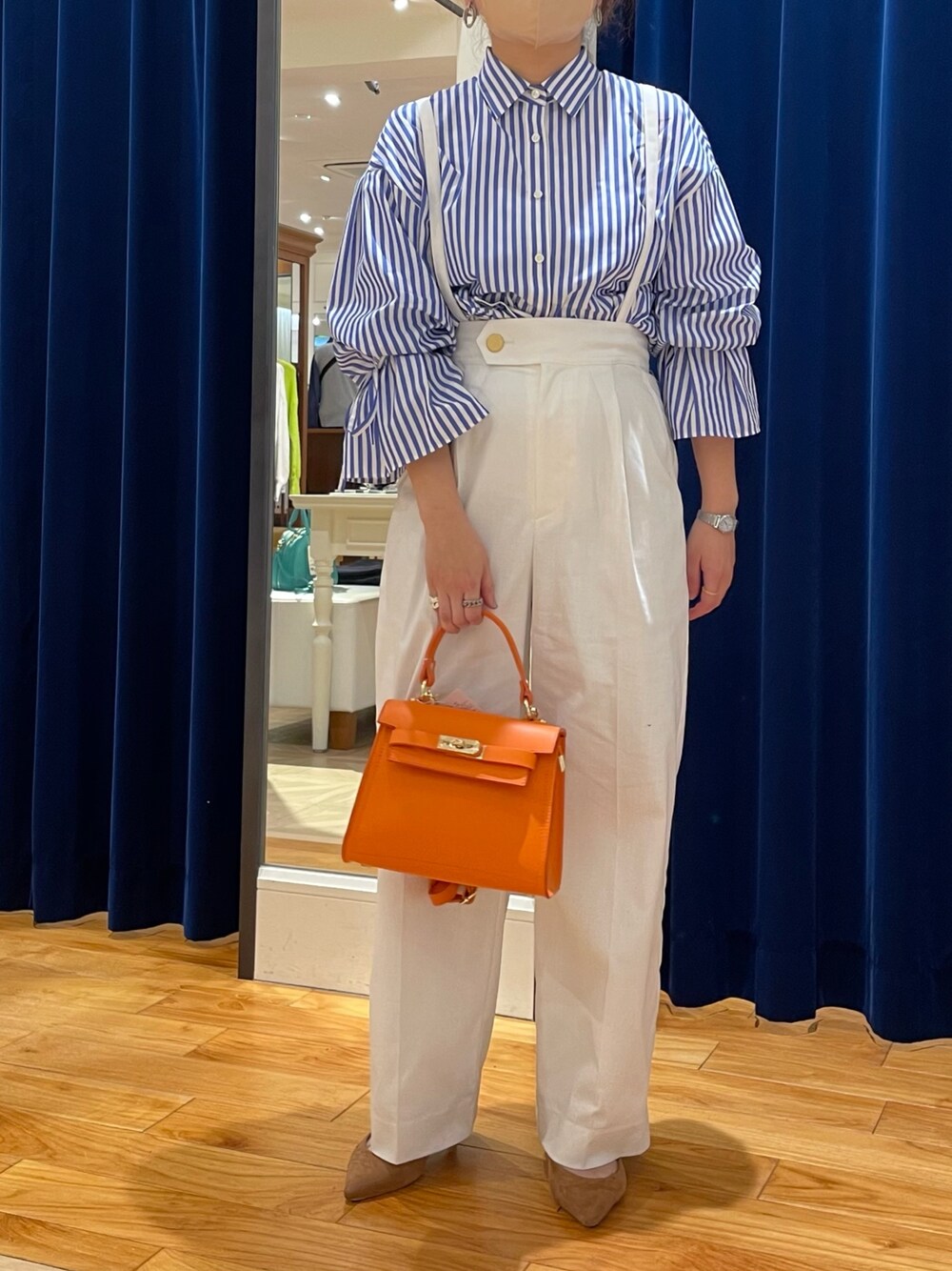 ブルー系のシャツ/ブラウス、ホワイト系のその他パンツ、オレンジ系のショルダーバッグを着用したレディースの春コーディネートの1枚目の写真