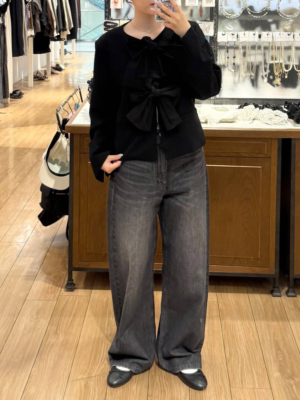 ブラック系のノーカラージャケット、ブラック系のバレエシューズ、ブラック系のデニムパンツを着用したレディースの秋コーディネートの1枚目の写真