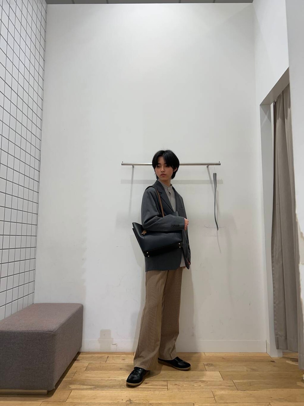 ブラック系のトートバッグ、ブラウン系のその他パンツ、ブラック系のスニーカーを着用したメンズの春コーディネートの1枚目の写真