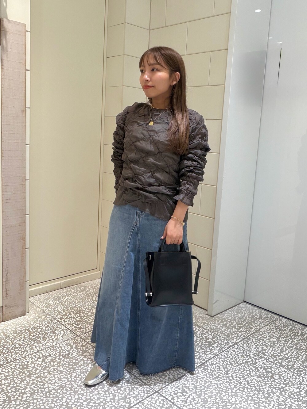 ブルー系のスカート、グレー系のその他トップス、ブラック系のショルダーバッグを着用したレディースの夏コーディネートの1枚目の写真