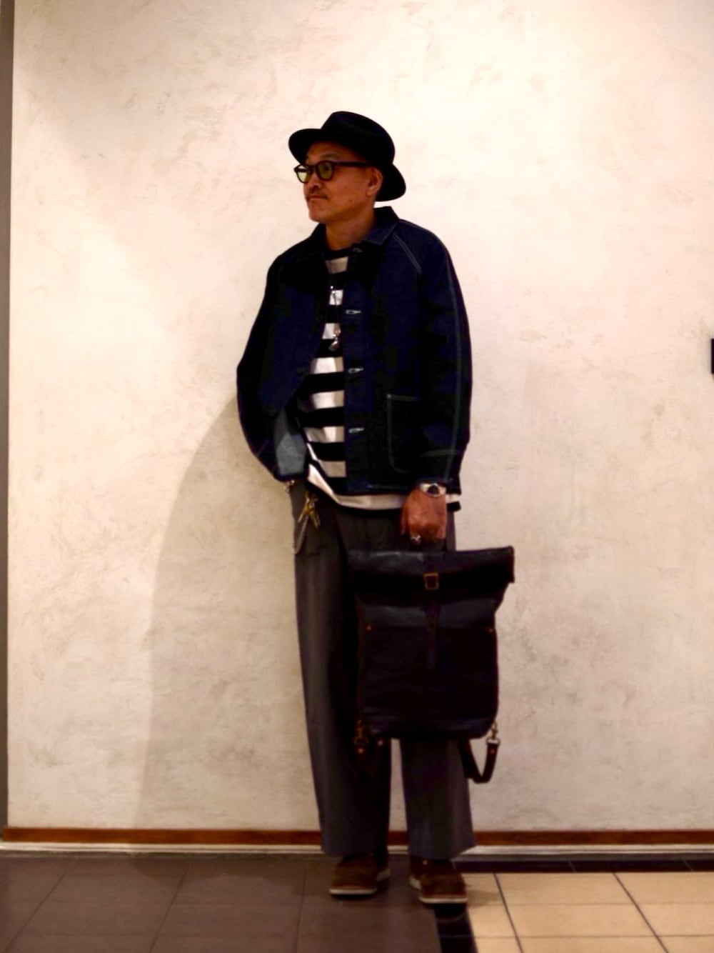 ブラック系のバックパック/リュック、ブラック系のその他パンツ、ブラック系のTシャツ/カットソーを着用したメンズの春コーディネートの1枚目の写真