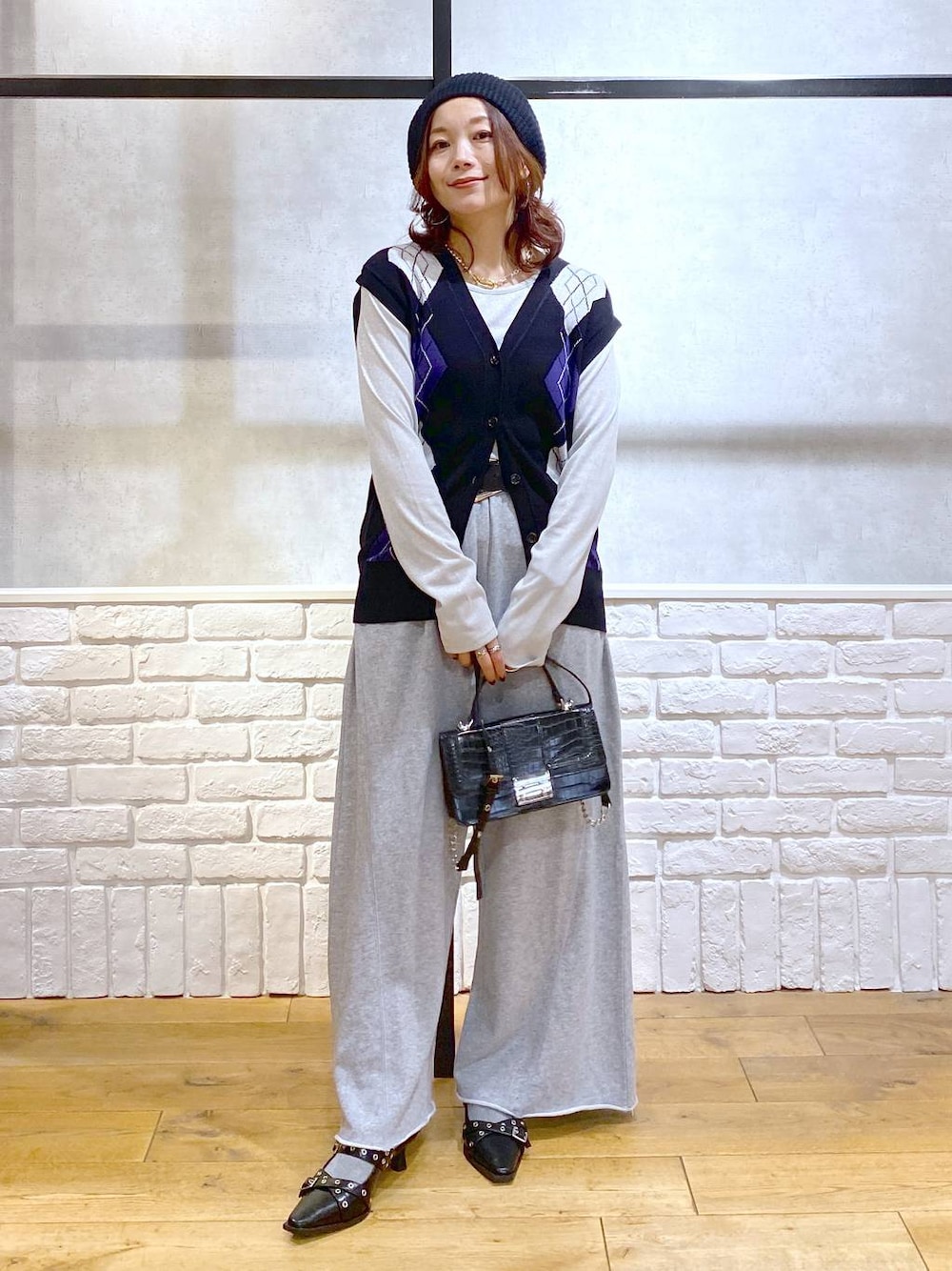 ブラック系のパンプス、グレー系のスウェットパンツ、ブラック系のハンドバッグを着用したレディースの秋コーディネートの1枚目の写真