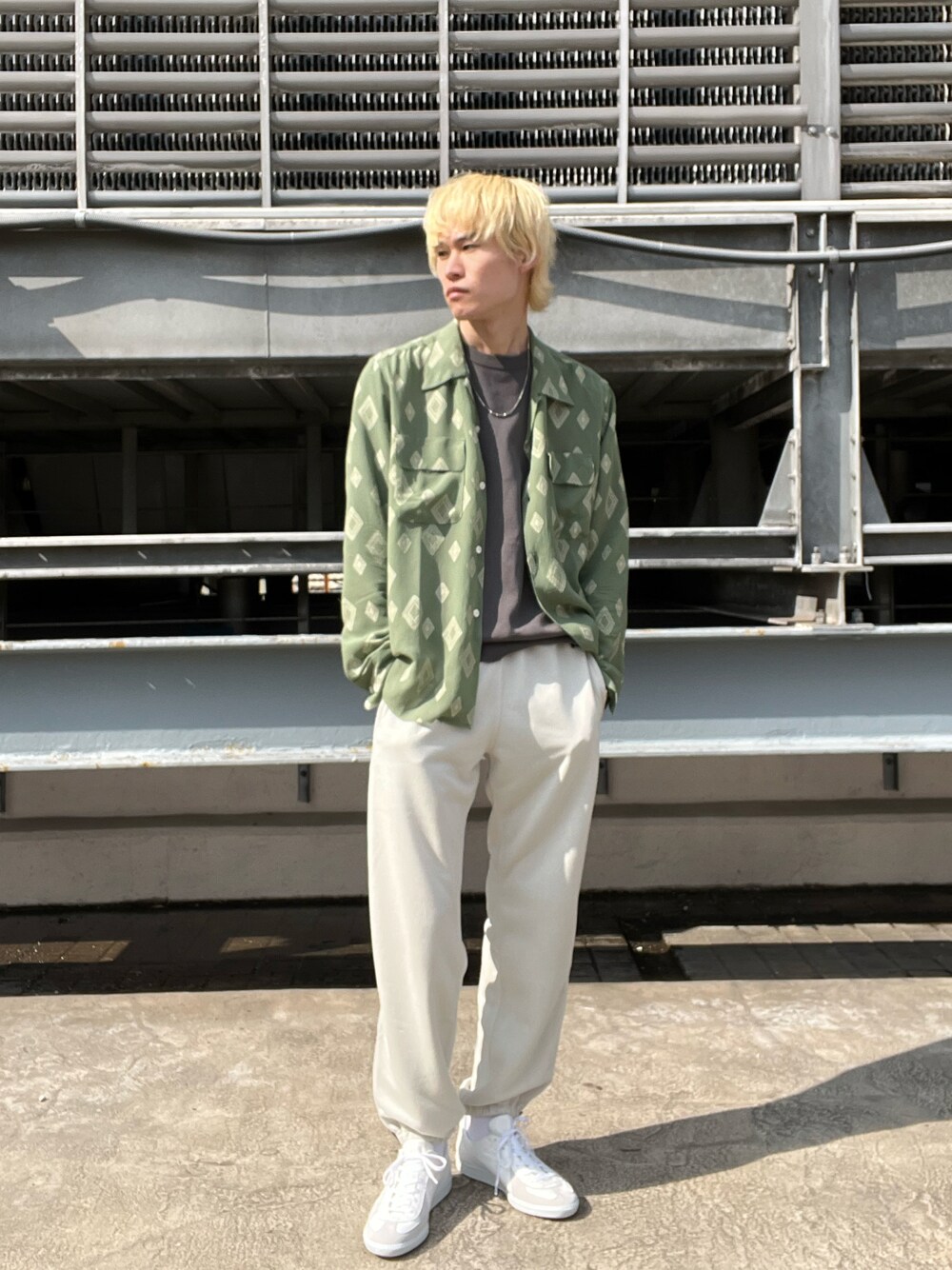 ホワイト系のパンツ、グリーン系のシャツ/ブラウス、グリーン系のニット/セーターを着用したメンズの春コーディネートの1枚目の写真