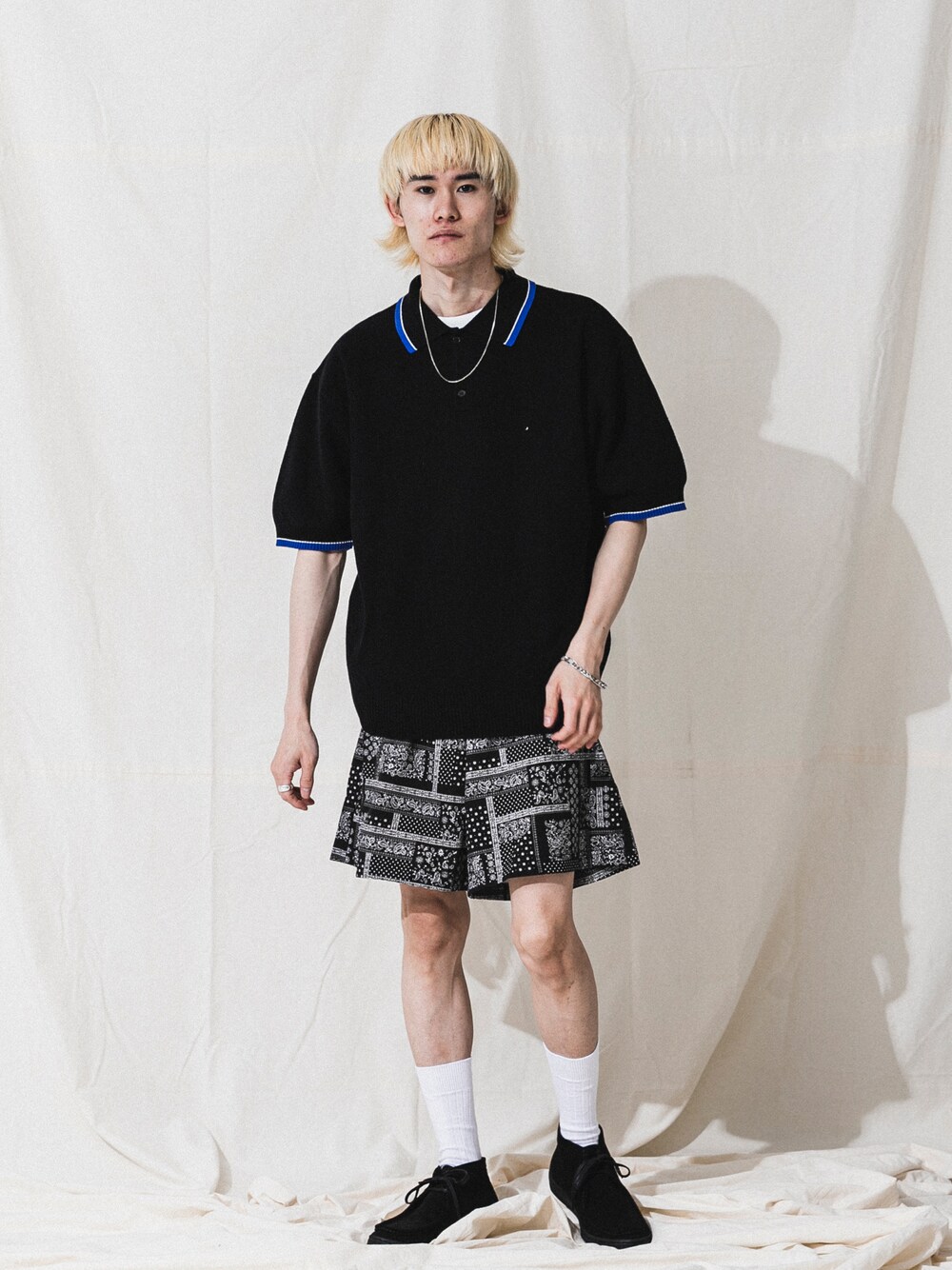 ベージュ系のポロシャツ、シルバー系のネックレスを着用したメンズの春コーディネートの1枚目の写真