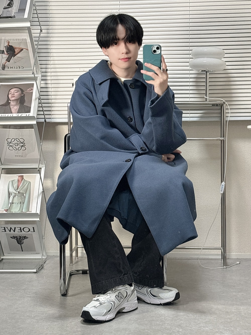 ブルー系のステンカラーコート、グレー系のデニムパンツ、ホワイト系のスニーカーを着用したメンズの冬コーディネートの1枚目の写真