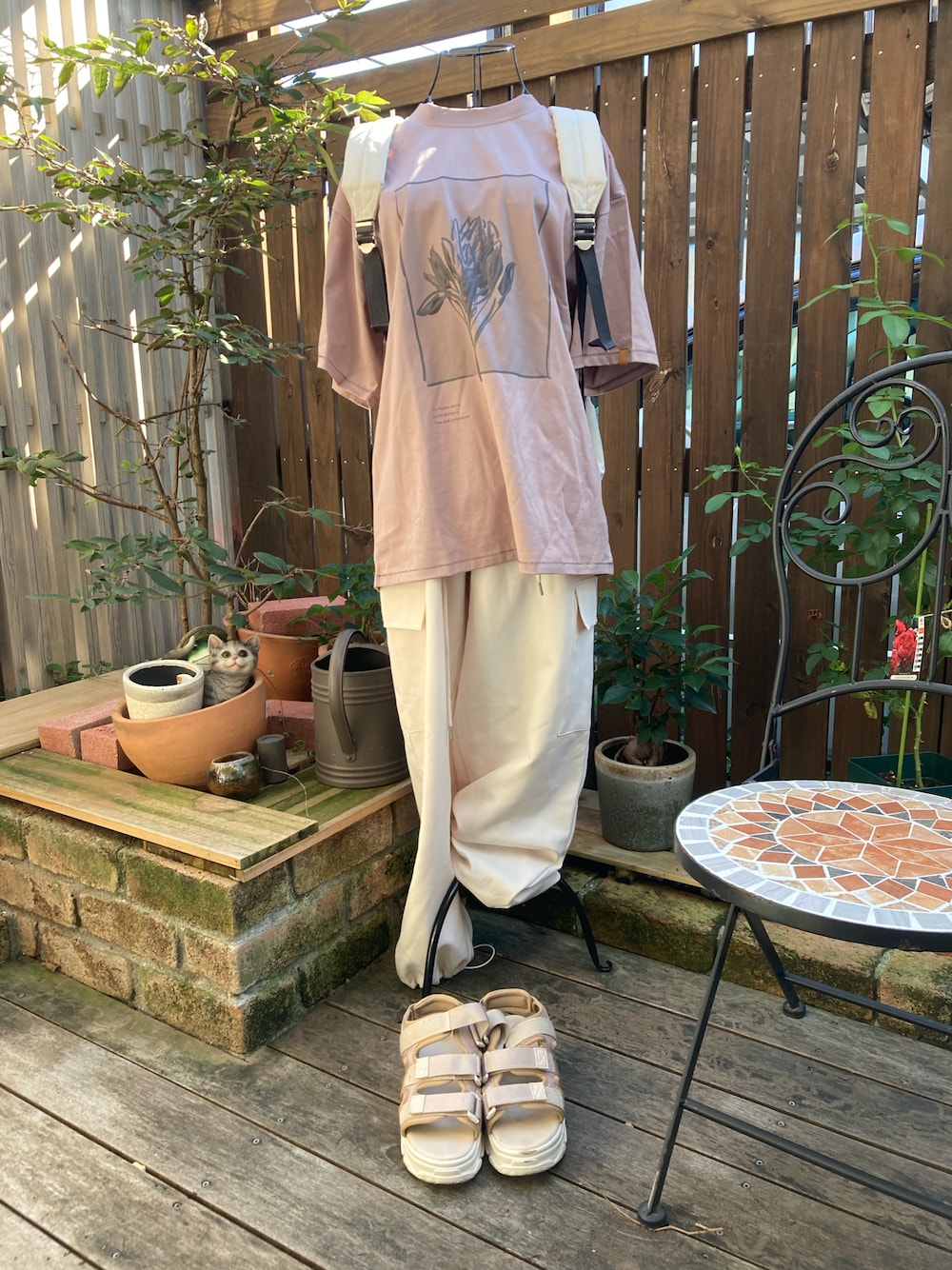 ベージュ系のサンダル、ホワイト系のカーゴパンツ、ピンク系のTシャツ/カットソーを着用したレディースの秋コーディネートの1枚目の写真