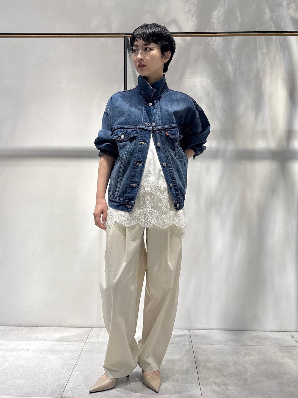 ホワイト系のキャミソール、ベージュ系のトレンチコート、ベージュ系のその他パンツを着用したレディースの冬コーディネートの1枚目の写真