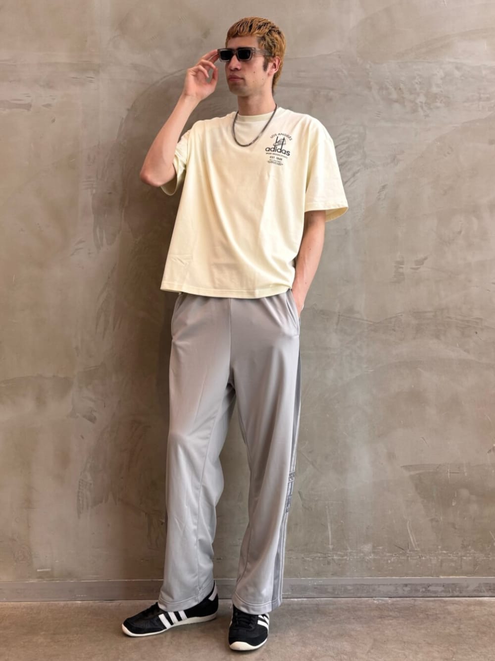 ブラック系のシューズ、グレー系のその他パンツ、ホワイト系のTシャツ/カットソーを着用したメンズの夏コーディネートの1枚目の写真