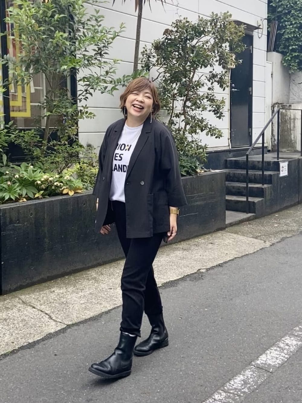 ブラック系のテーラードジャケット、ホワイト系のTシャツ/カットソー、ブラック系のスウェットパンツを着用したレディースの春コーディネートの1枚目の写真