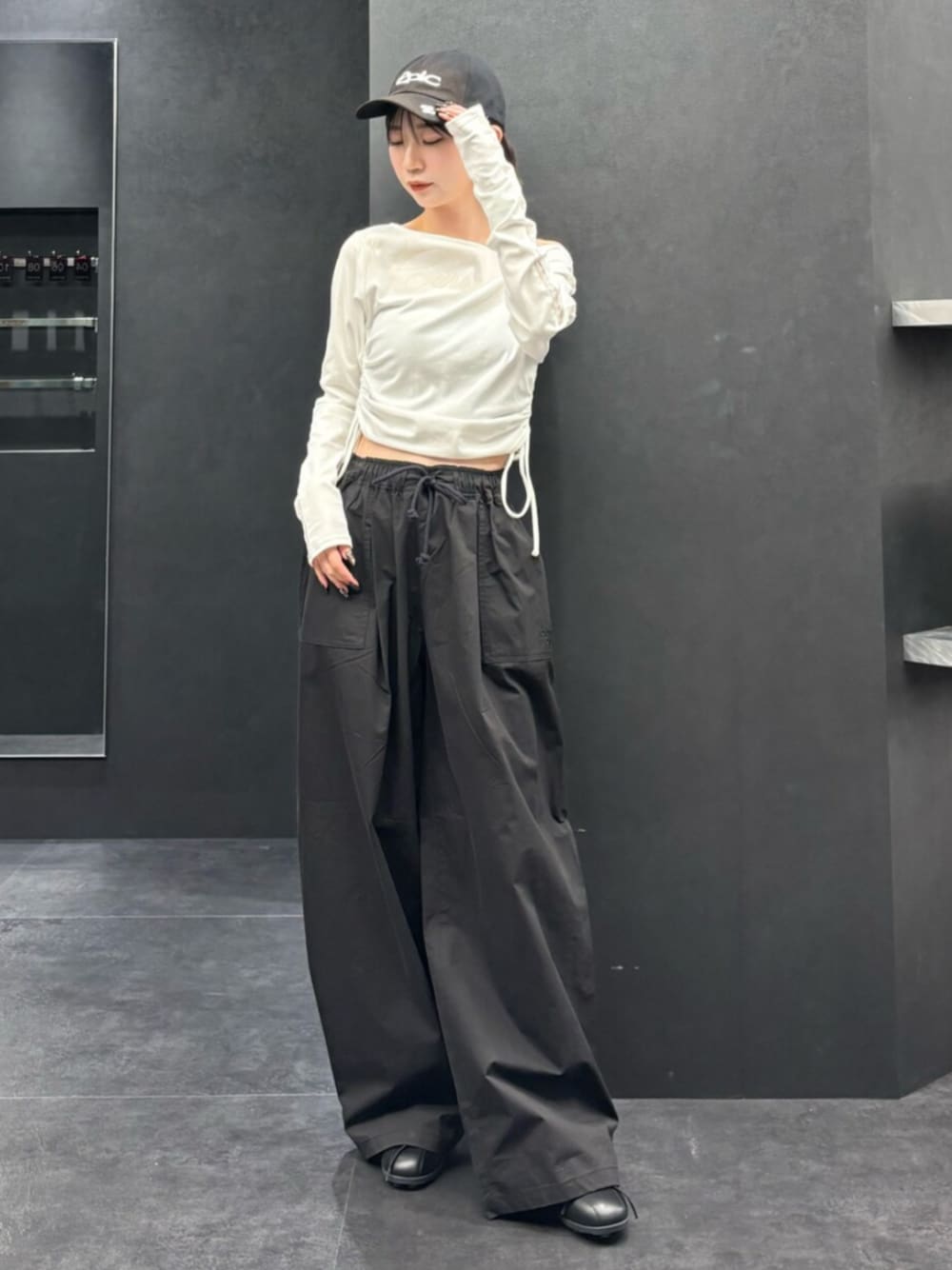 ブラック系のスニーカー、ホワイト系のTシャツ/カットソー、ブラック系のその他パンツを着用したレディースの春コーディネートの1枚目の写真