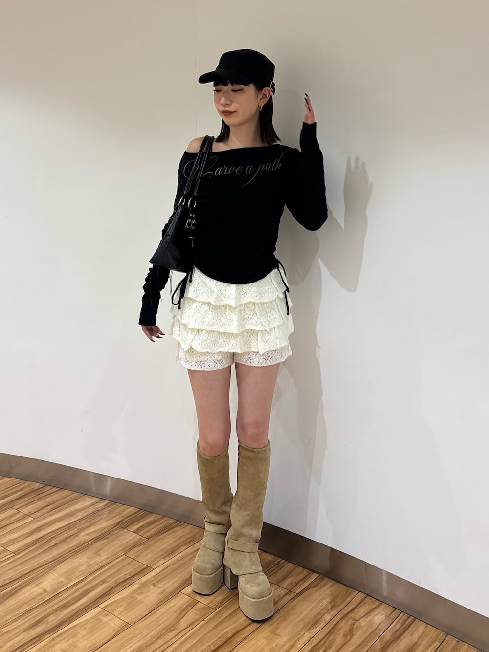 ブラック系のTシャツ/カットソー、ホワイト系のスカート、ベージュ系のブーツを着用したレディースの夏コーディネートの1枚目の写真