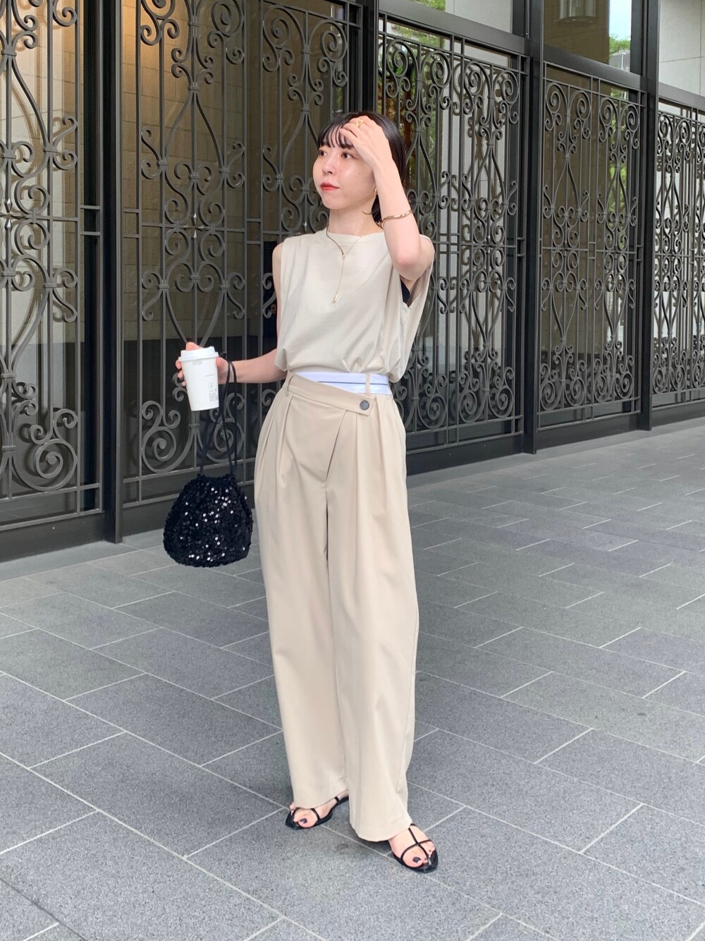 ベージュ系のTシャツ/カットソー、ブラック系のハンドバッグ、ベージュ系のその他パンツを着用したレディースの春コーディネートの1枚目の写真