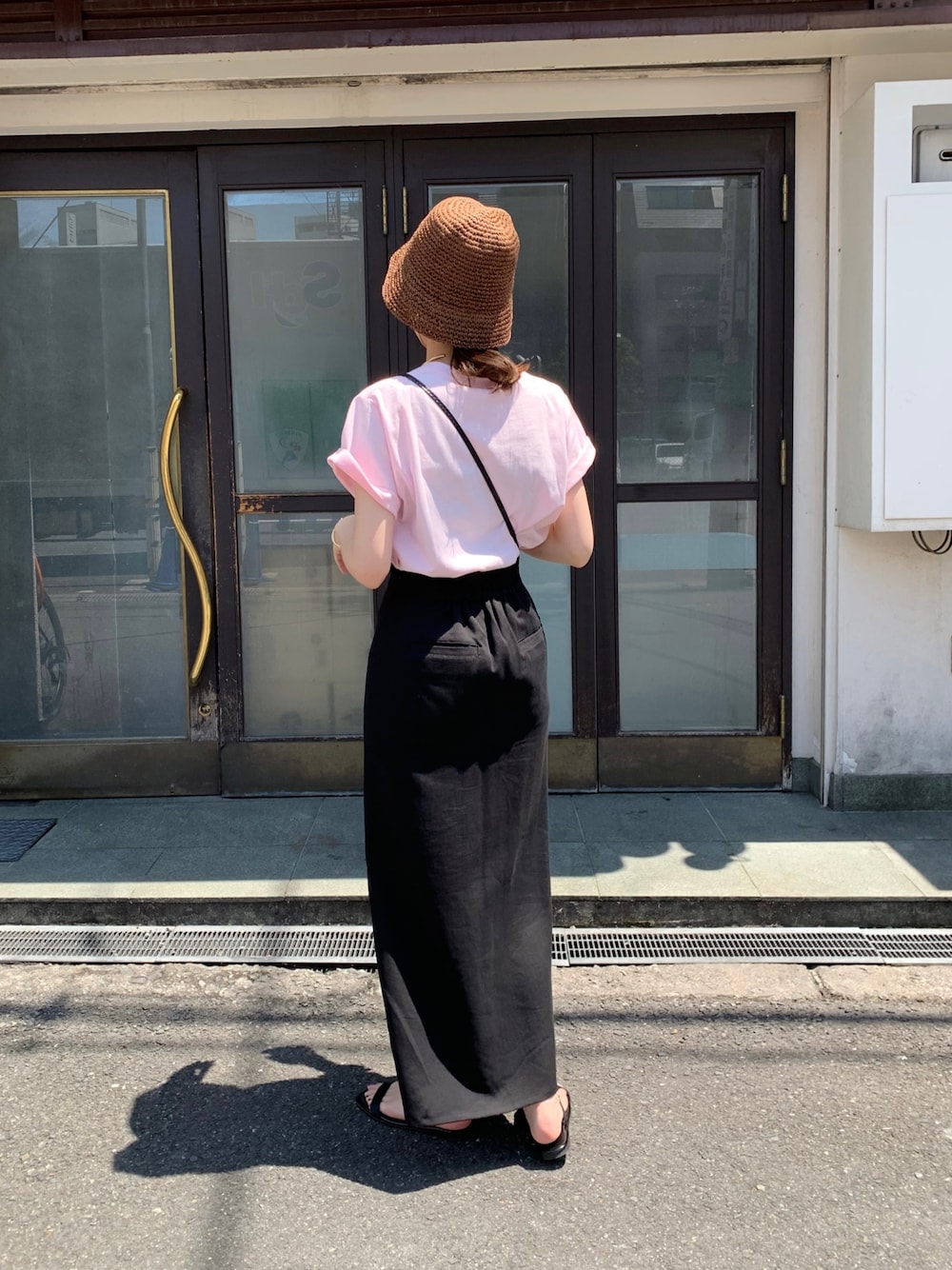 ピンク系のTシャツ/カットソー、ブラック系のショルダーバッグ、ブラック系のスカートを着用したレディースの春コーディネートの4枚目の写真