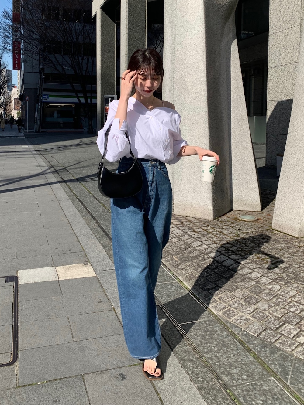 ホワイト系のシャツ/ブラウス、ブラック系のハンドバッグ、ブラック系のサンダルを着用したレディースの春コーディネートの1枚目の写真