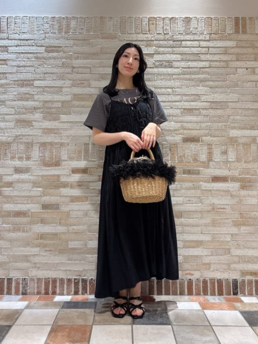 ブラック系のショルダーバッグ、ブラック系のパンプス、グレー系のTシャツ/カットソーを着用したレディースの夏コーディネートの1枚目の写真