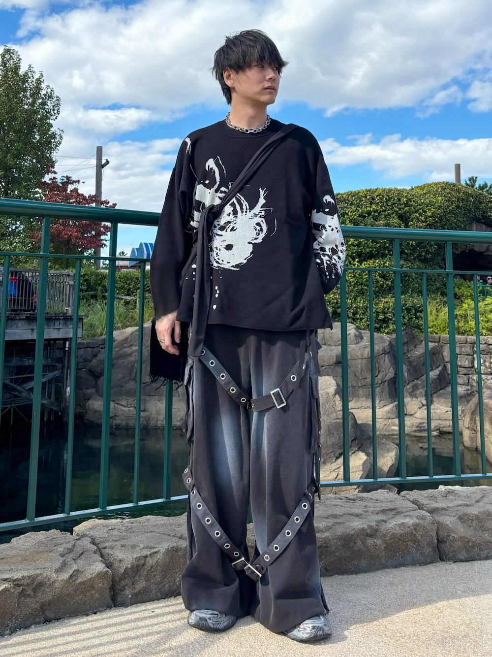 グレー系のスニーカー、グレー系のデニムパンツ、ブラック系のニット/セーターを着用したメンズの秋コーディネートの1枚目の写真