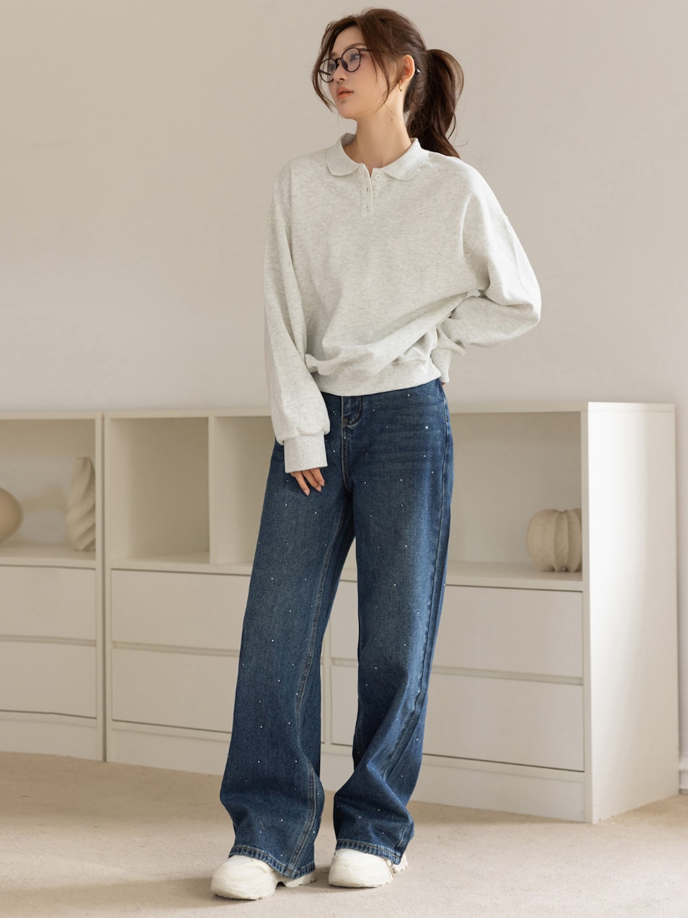 ブルー系のデニムパンツ、ホワイト系のスウェットを着用したレディースの秋コーディネートの1枚目の写真