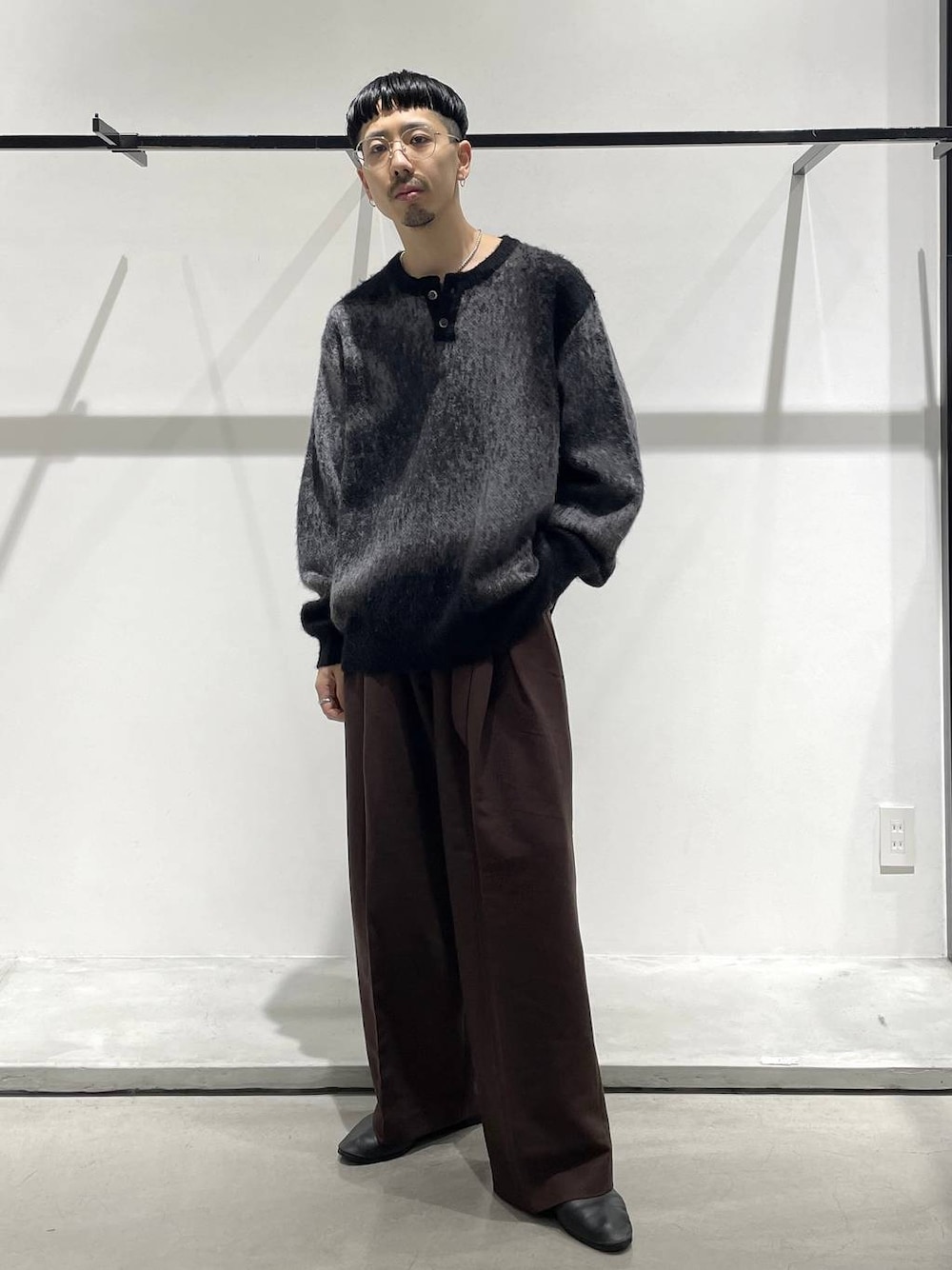 ブラック系のバレエシューズ、ブラック系のニット/セーター、シルバー系のネックレスを着用したメンズの冬コーディネートの1枚目の写真