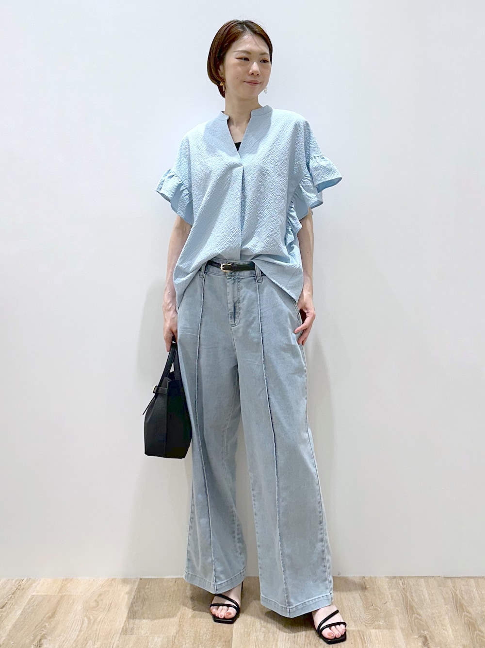 ブルー系のシャツ/ブラウス、ブラック系のタンクトップ、ブルー系のデニムパンツを着用したレディースの夏コーディネートの1枚目の写真