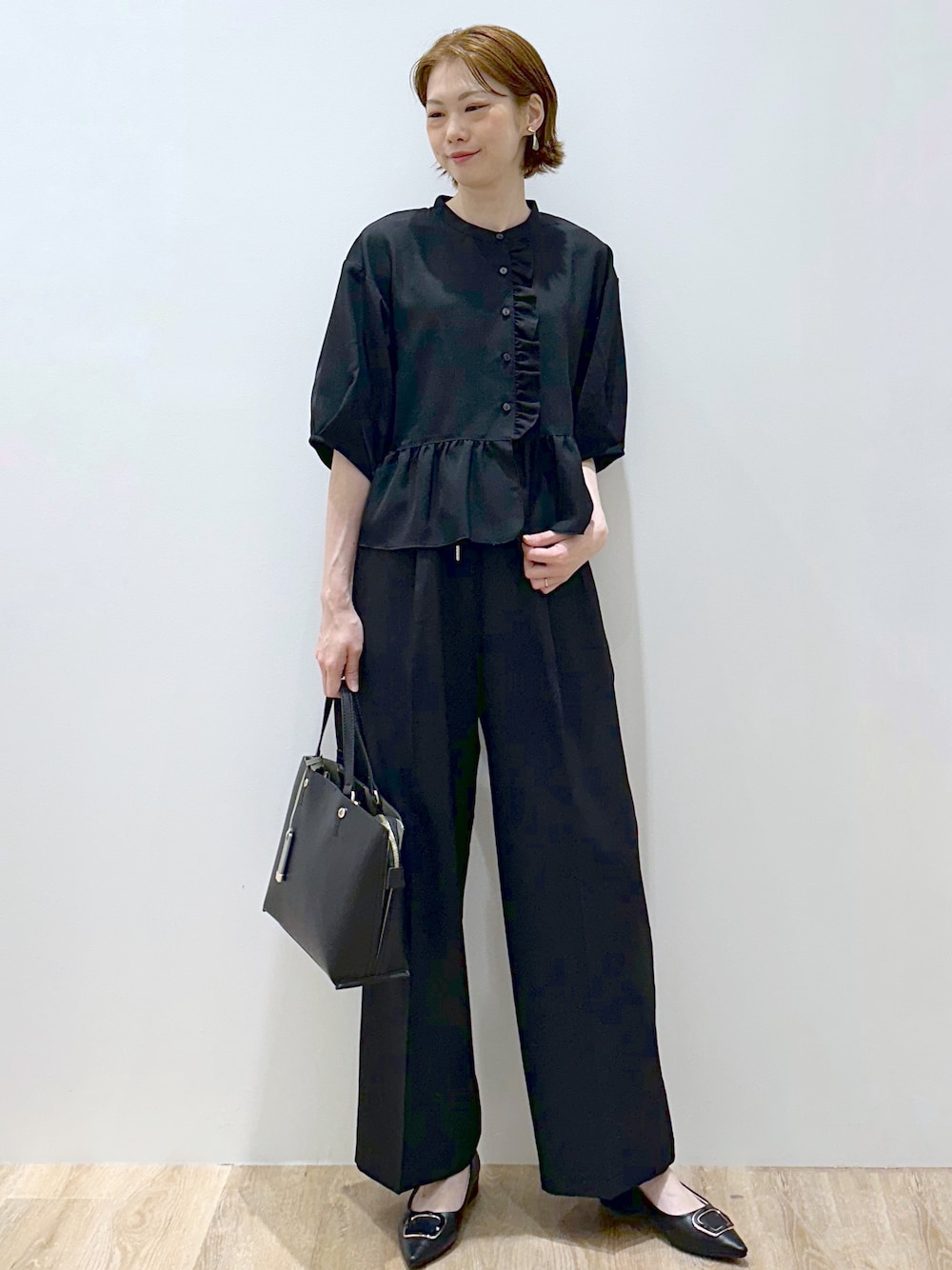 ブラック系のシャツ/ブラウス、ブラック系のその他パンツ、ブラック系のトートバッグを着用したレディースの秋コーディネートの1枚目の写真