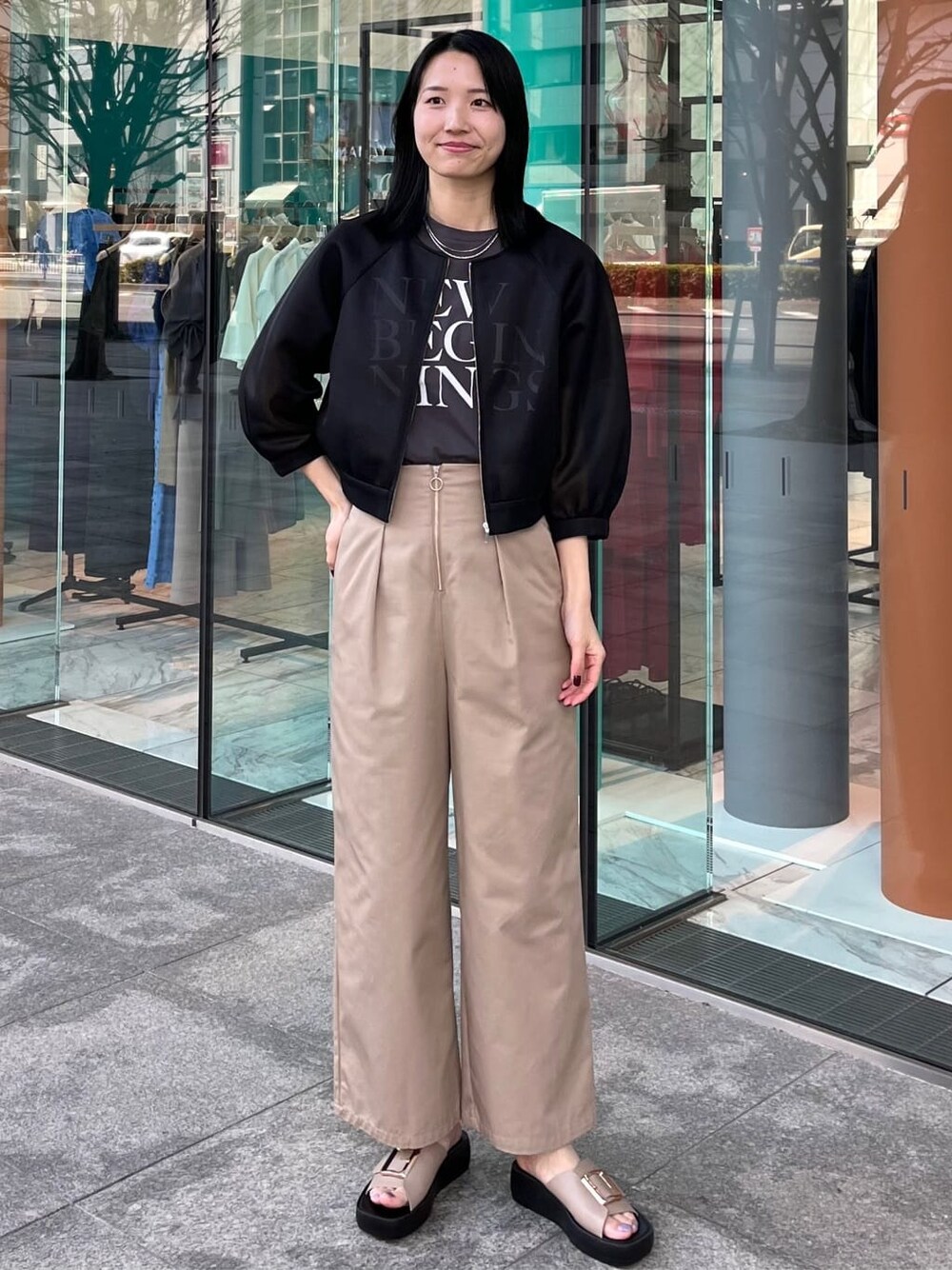 ブラック系のブルゾン、グレー系のTシャツ/カットソー、ベージュ系のその他パンツを着用したレディースの春コーディネートの1枚目の写真