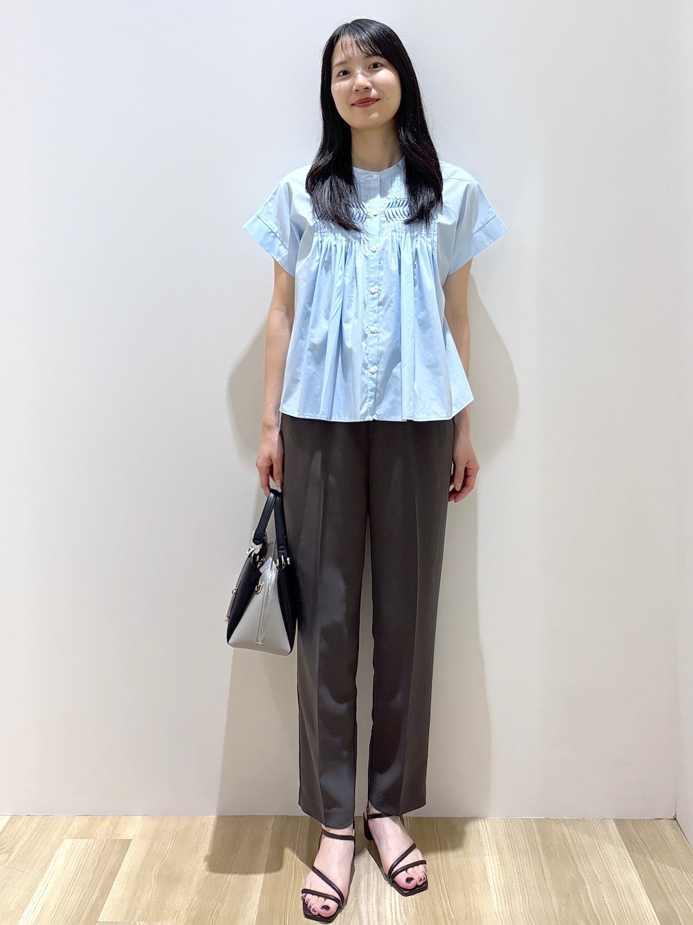 ブルー系のシャツ/ブラウス、グレー系のその他パンツ、ブラック系のショルダーバッグを着用したレディースの夏コーディネートの1枚目の写真