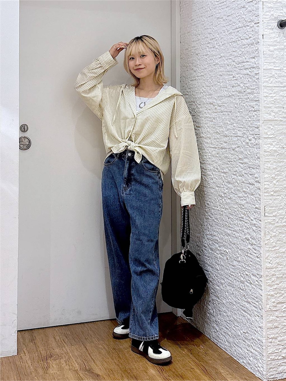 ブルー系のデニムパンツ、ブラック系のスニーカー、グレー系のタンクトップを着用したレディースの夏コーディネートの1枚目の写真