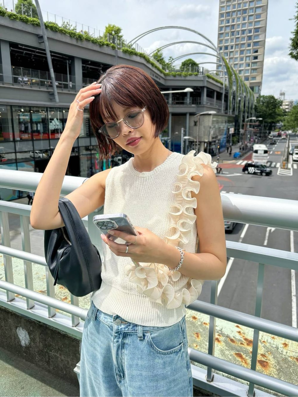 ホワイト系のタンクトップ、ブルー系のデニムパンツ、グレー系のサングラスを着用したレディースの夏コーディネートの1枚目の写真
