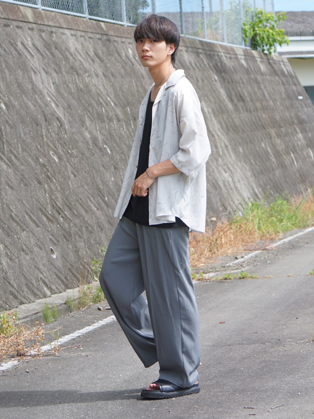 ベージュ系のシャツ/ブラウス、ブルー系のスラックス、ブラック系のサンダルを着用したメンズの夏コーディネートの1枚目の写真