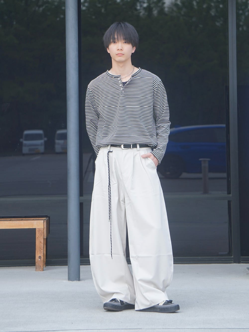ブラック系のTシャツ/カットソー、ベージュ系のスラックス、ブラック系のタンクトップを着用したメンズの春コーディネートの1枚目の写真