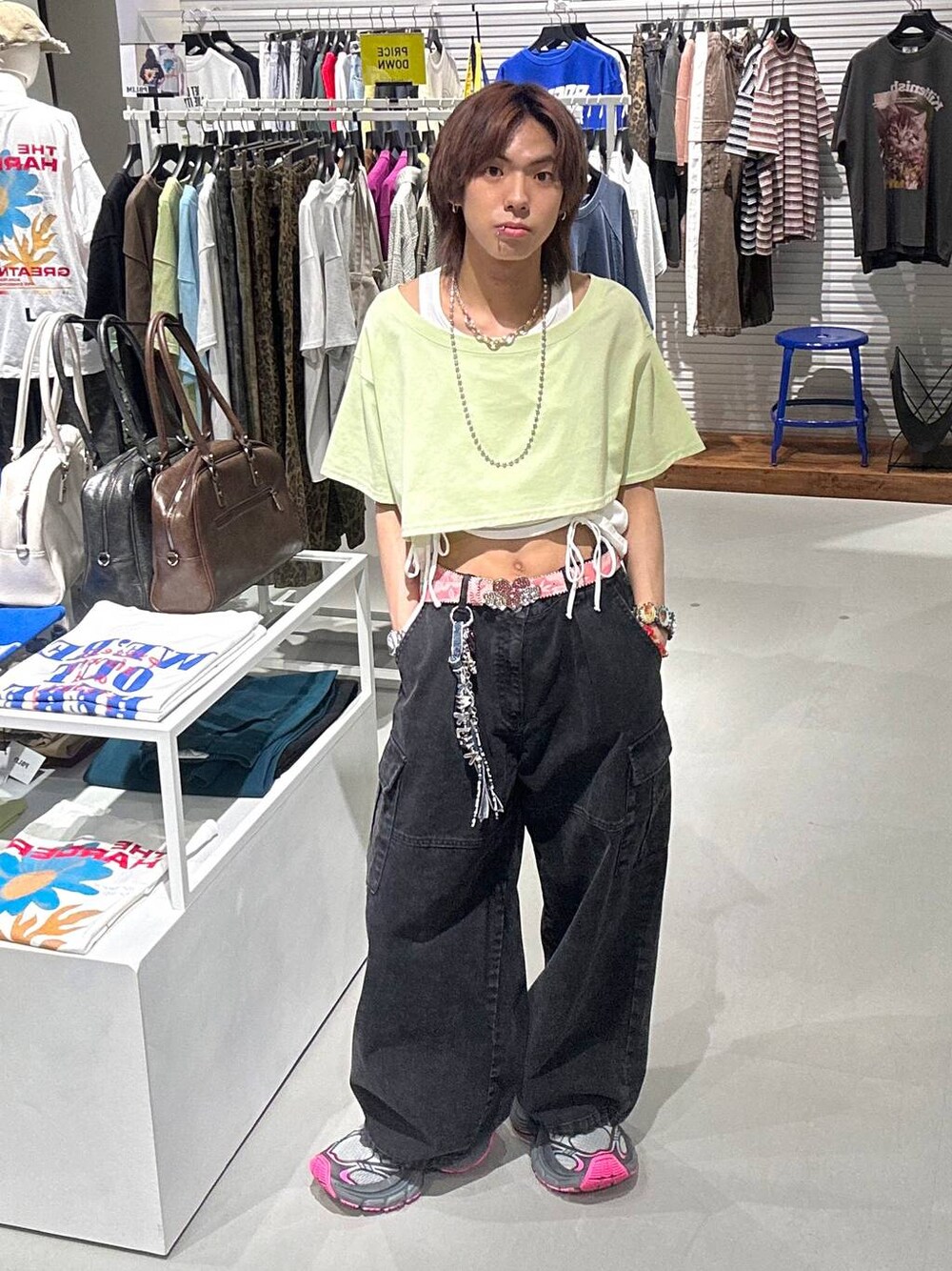 ブラック系のカーゴパンツ、グリーン系のTシャツ/カットソー、ブラック系のネックレスを着用したメンズの春コーディネートの1枚目の写真