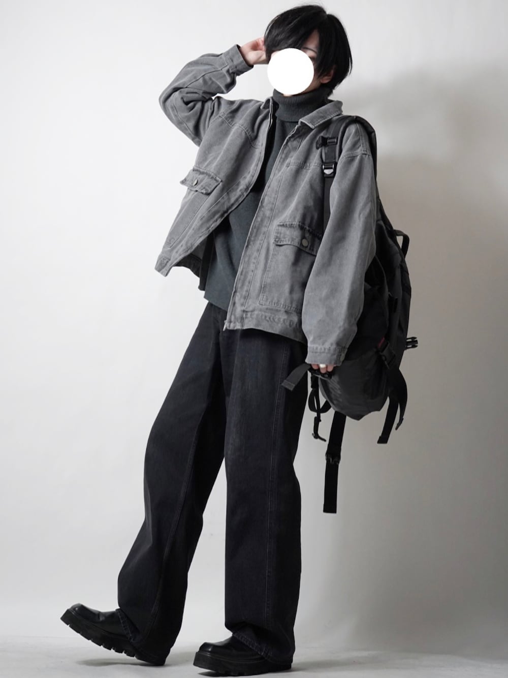 ブラック系のデニムパンツ、ブラック系のバックパック/リュック、グレー系のデニムジャケットを着用したメンズの冬コーディネートの1枚目の写真