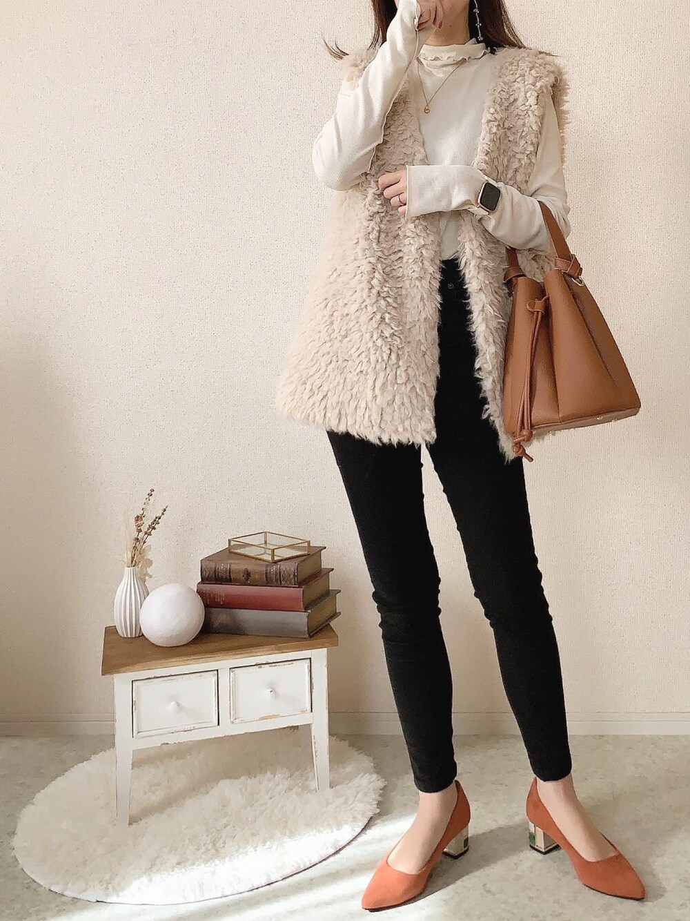 ブラック系のデニムパンツ、オレンジ系のパンプスを着用したレディースの秋コーディネートの1枚目の写真