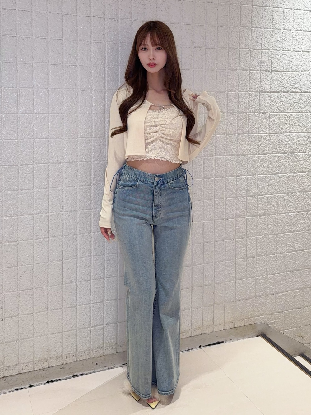 イエロー系のTシャツ/カットソー、ブルー系のデニムパンツ、イエロー系のサンダルを着用したレディースの春コーディネートの1枚目の写真