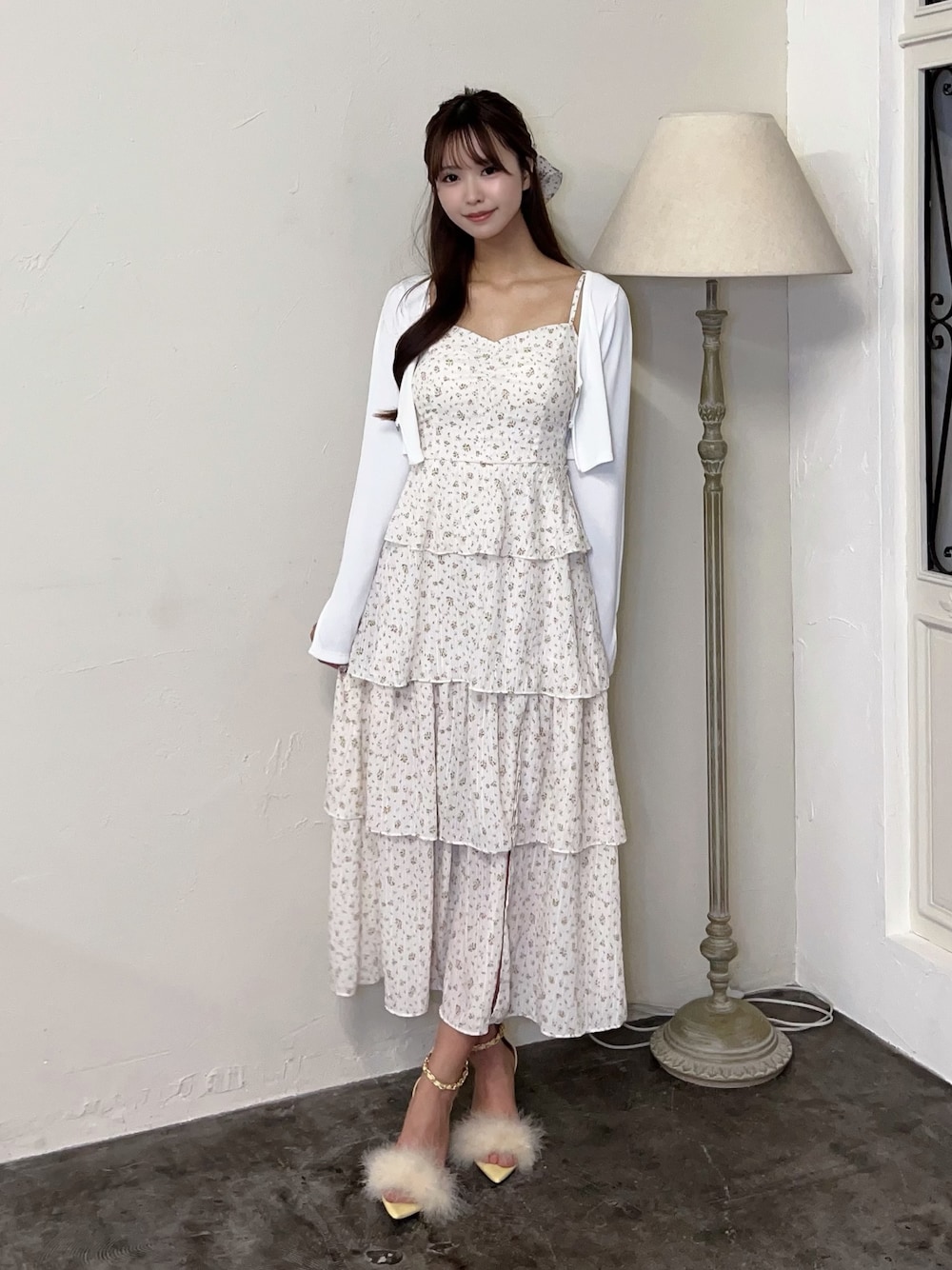 ホワイト系のワンピース、ホワイト系のTシャツ/カットソー、イエロー系のサンダルを着用したレディースの春コーディネートの1枚目の写真