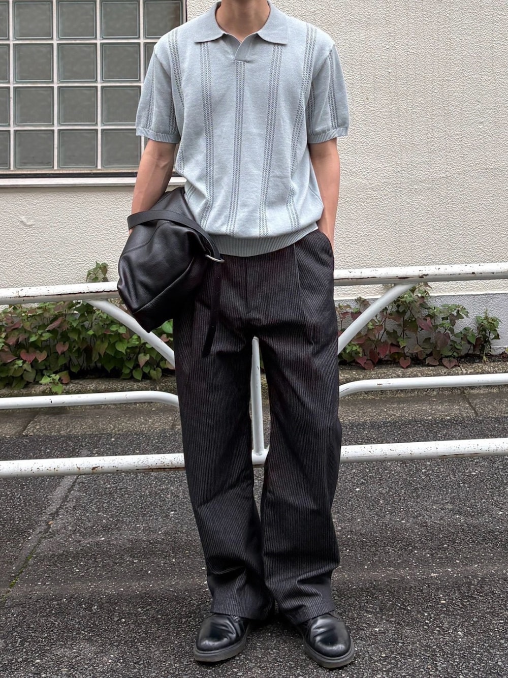 ブラック系のデニムパンツ、ブルー系のポロシャツを着用したメンズの夏コーディネートの1枚目の写真